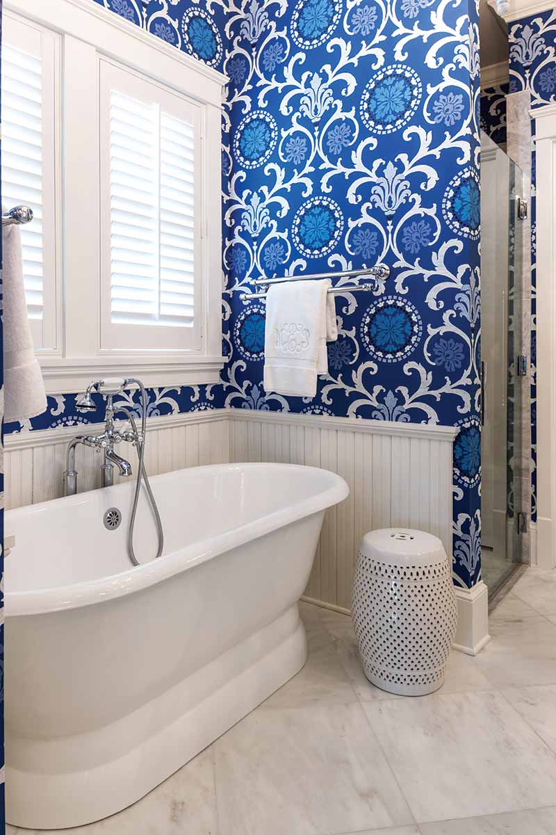 bathroom with blue accent wallpaper