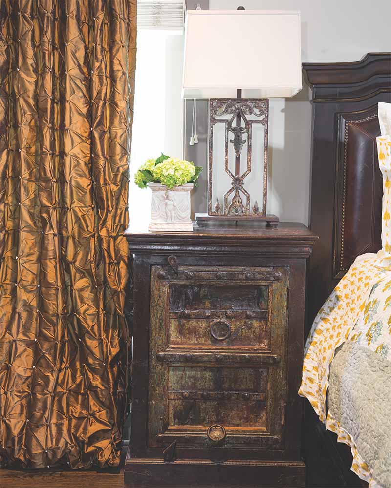 Antique weathered nightstand in a master bedroom. 