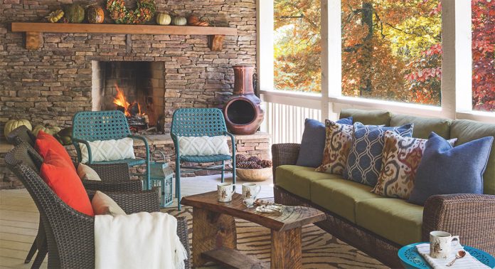 A back porch living area with a stone fireplace.
