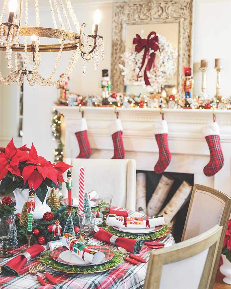 A holiday tablescape featuring red-and-green plaid and nutcracker accents. 