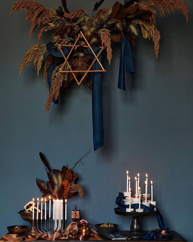 A Hanukkah tabletop vignette with dried florals and silk ribbons. 