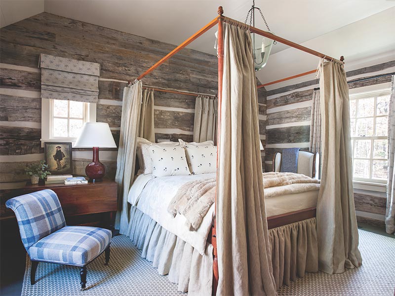 A rustic bedroom with a canopy bed and decorated with neutral accents.
