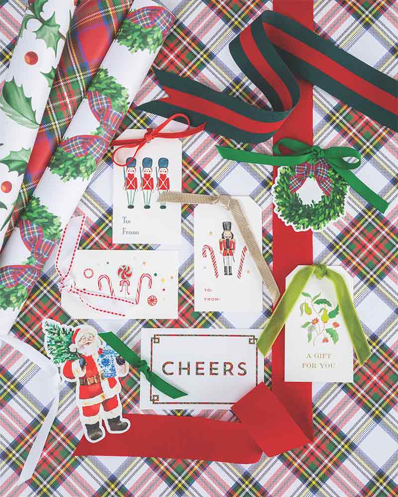 An assortment of holiday gift wrap, ribbon, and gift tags. 
