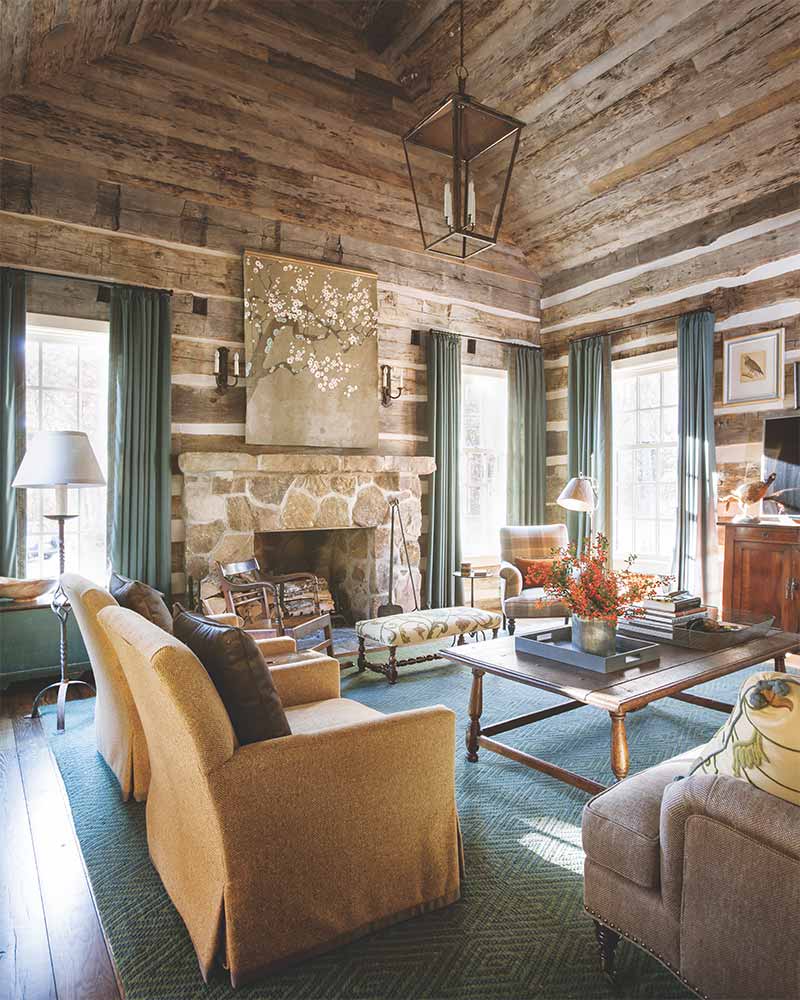 A Tennessee log cabin's rustic living room decorated with a warm autumn palette.