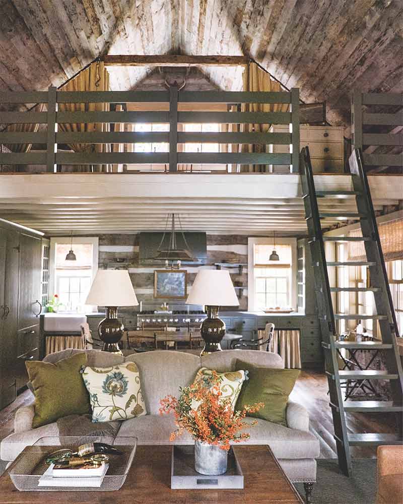A ladder leading to the loft of this Tennessee log cabin designed by Tammy Connor.