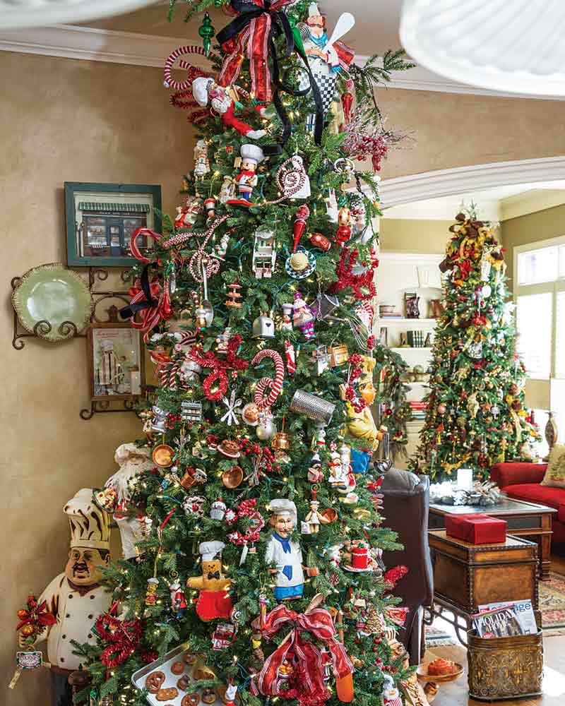 A pair of Christmas trees with the kitchen tree featured chef ornaments.