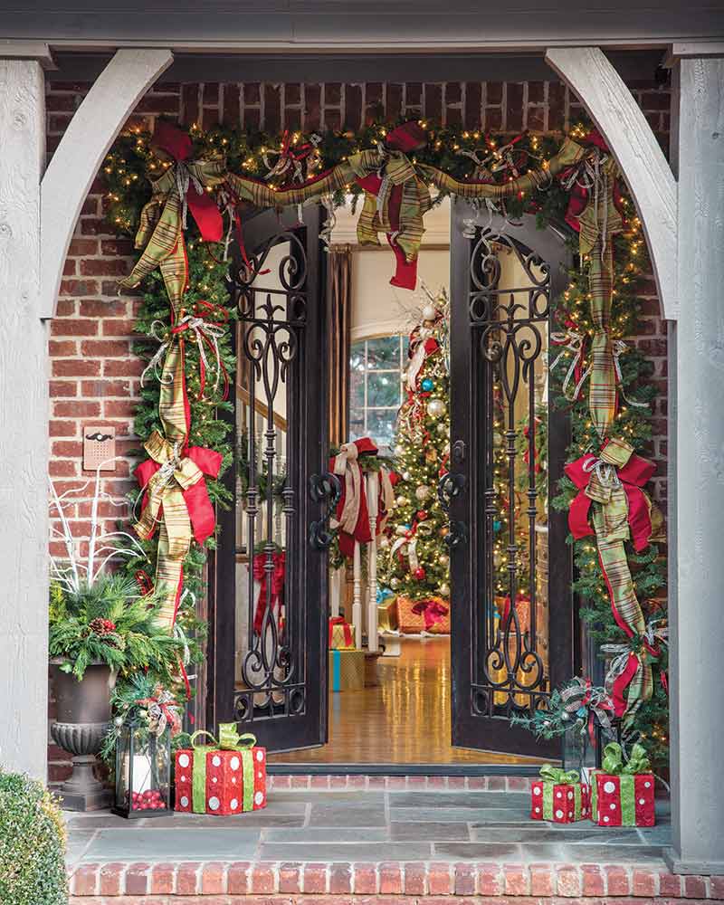 An entry adorned with a garland embellished with colorful ribbons.