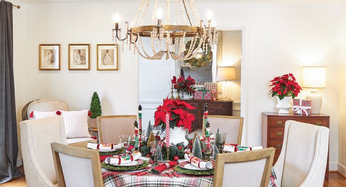 A tablescape with tartan linens, a poinsettia centerpiece, and whimsical accents.