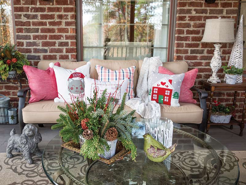 A patio area decorated with holiday-themed throw pillows.