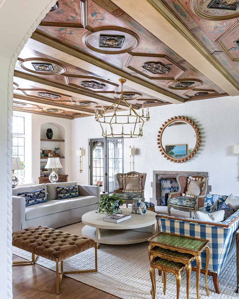 The living room of a home with an intricate wood ceiling design.