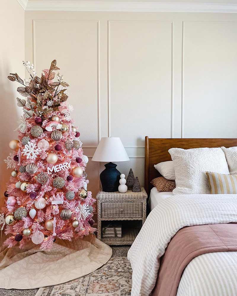 A bedroom with a pink tree. 