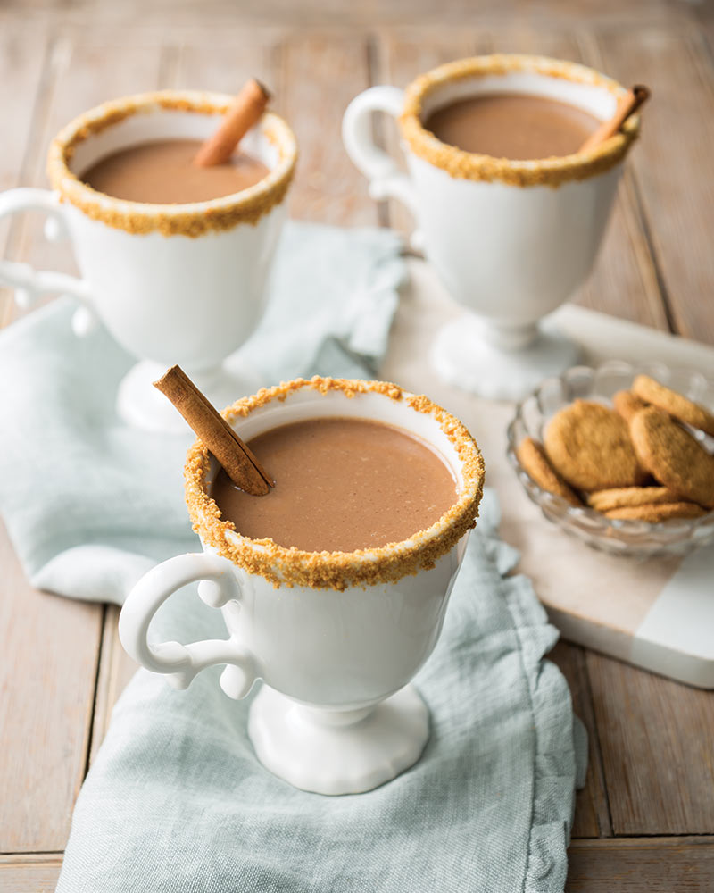 Three white footed-mugs of Gingerbread Hot Chocolate. 