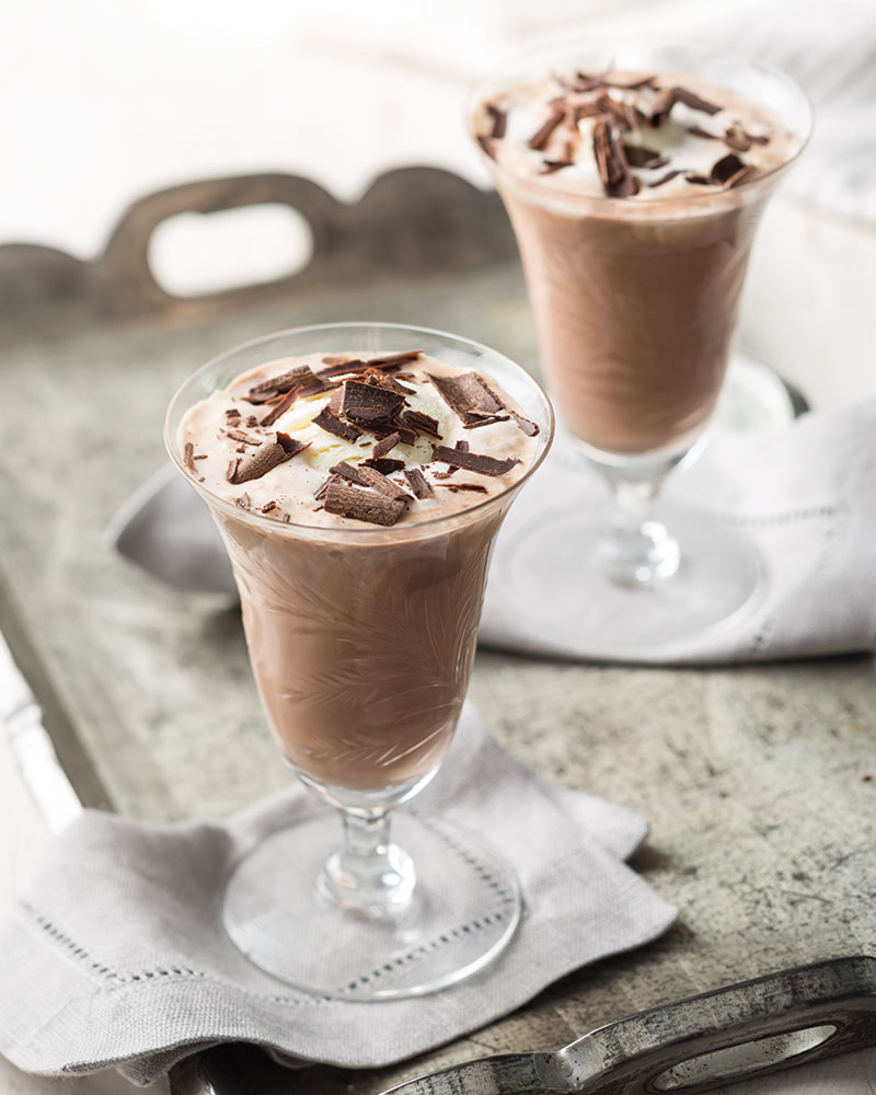 Two glass flutes on a tray with Hot Chocolate Floats