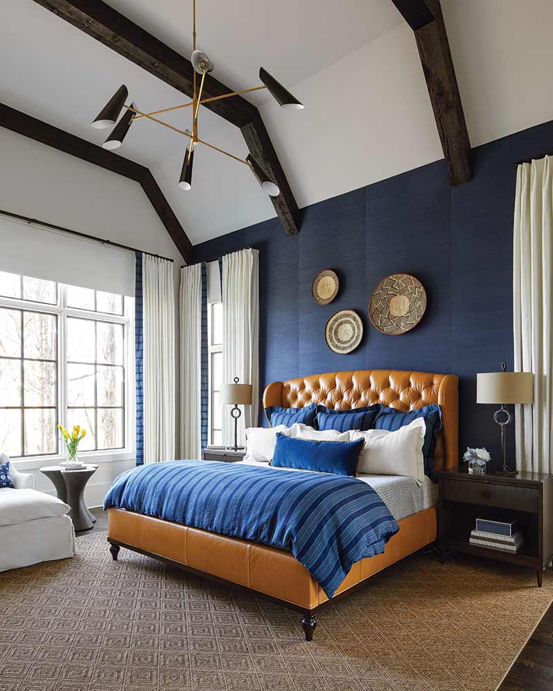 A bedroom decorated in a blue and white palette. 