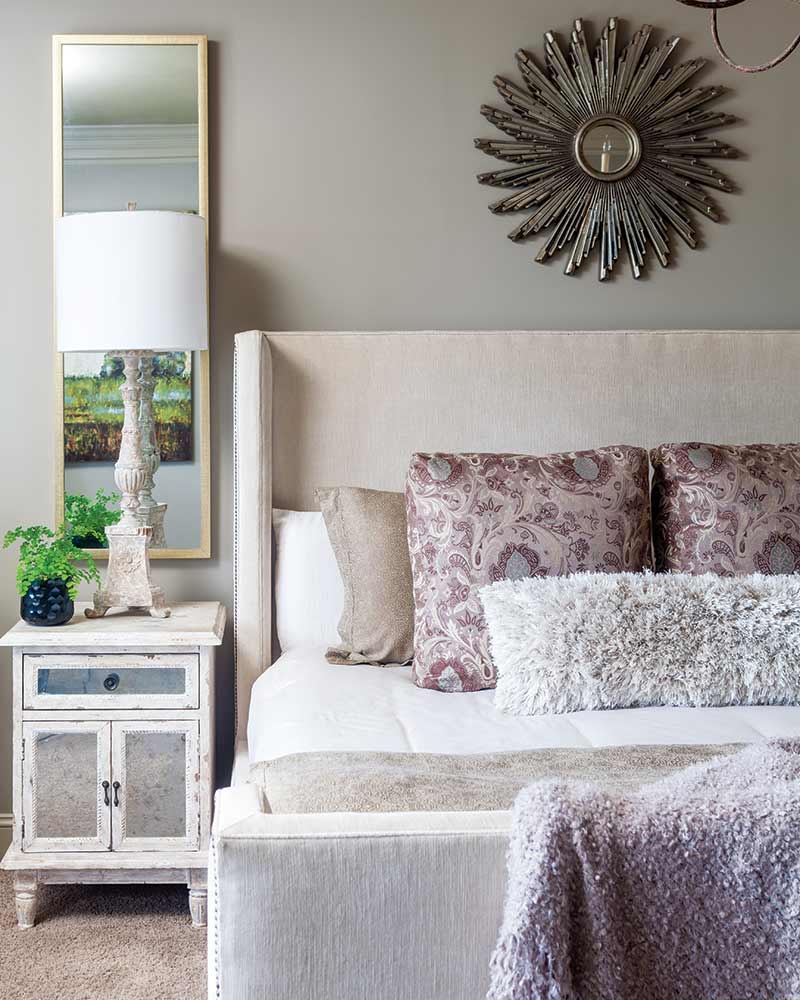 A bedroom decorated in beige and purple.