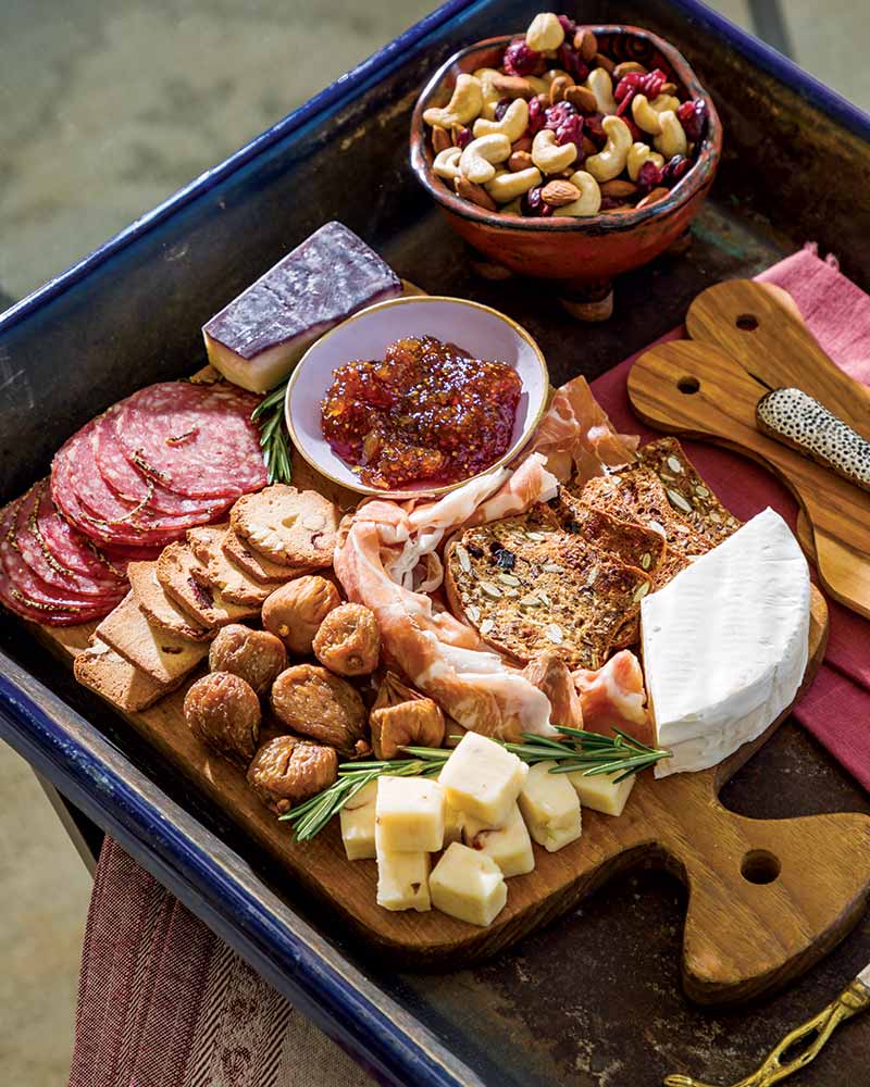A charcuterie board served on a ceramic tray. 