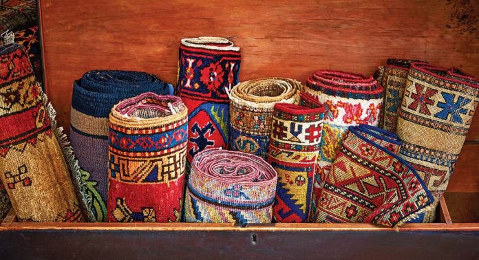A trunk filled with antique rugs