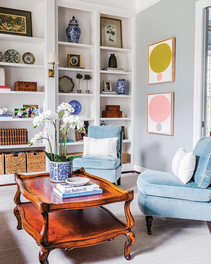 A living room with built-ins that feature antique accessories.
