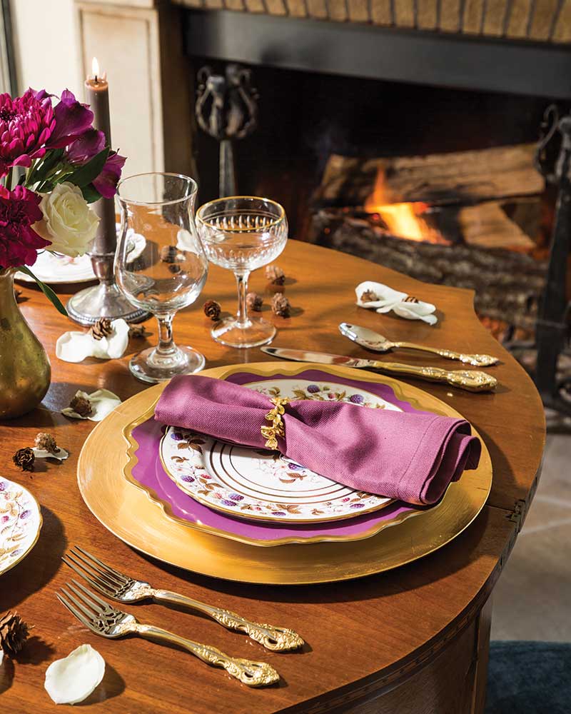 A purple-and-gold placesetting for an intimate fireside dinner.
