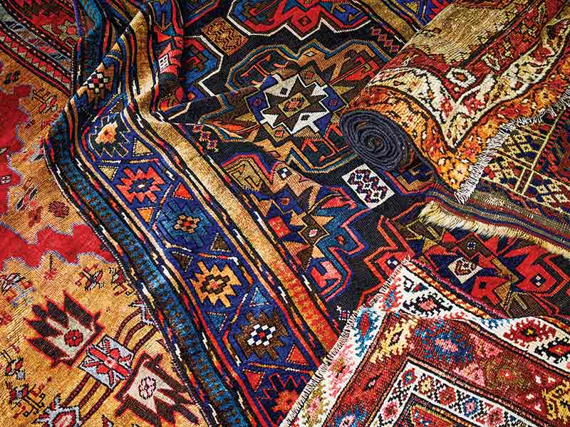 A stack of antique rugs.