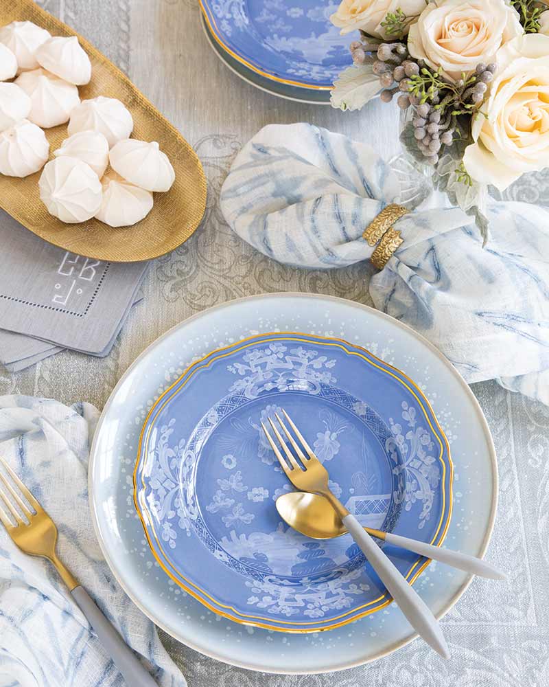 A tablescape with blue, white, and gold accents.