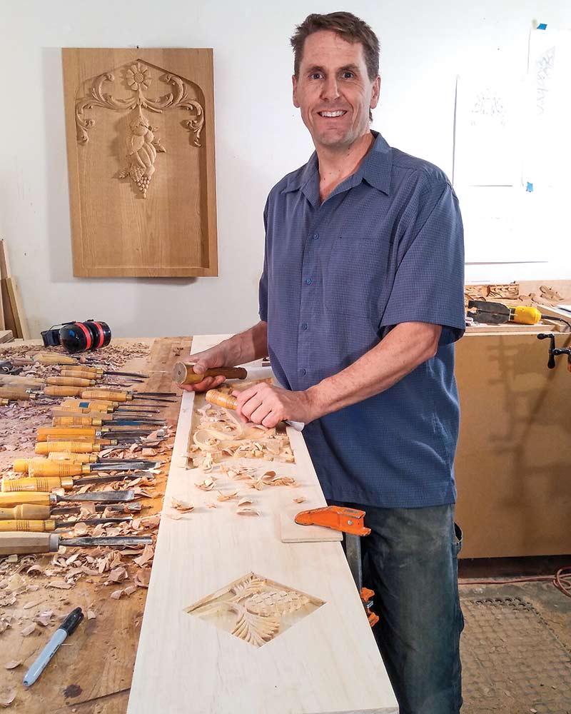 A portrait of Erik Wyckoff in his wood-carving studio.