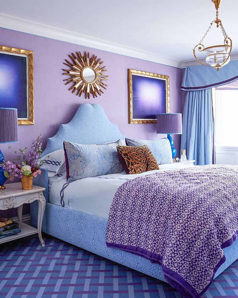 A purple bedroom with gold accents.