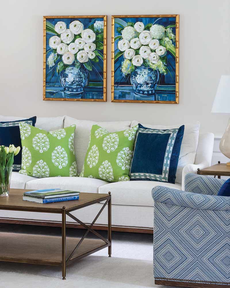 A living room with blue and green throw pillows and furnishings.