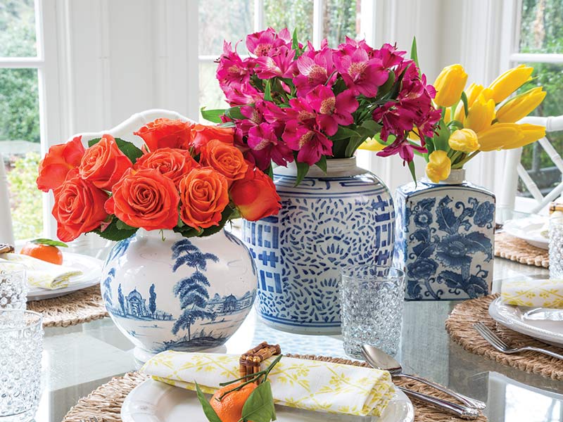 Three chinoiserie ginger jars with colorful blooms.