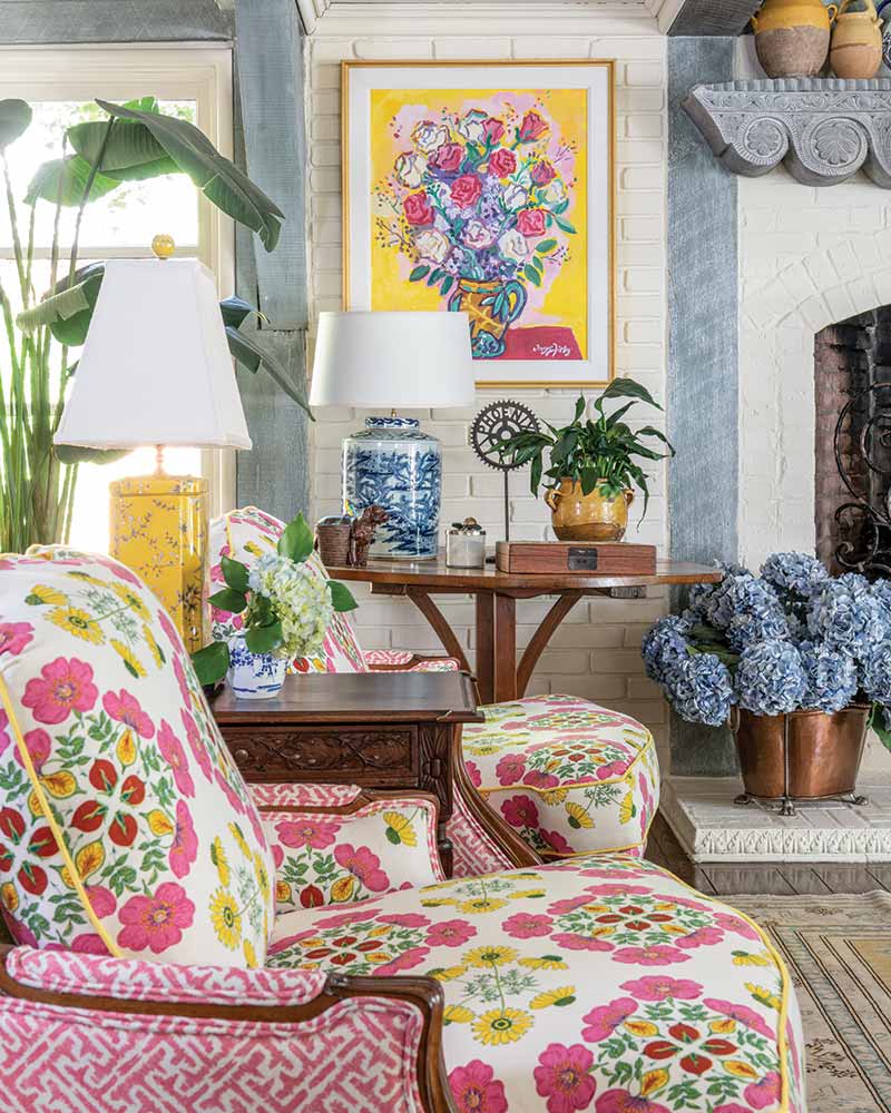 A living room with pink-and-yellow patterned furniture. 