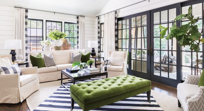 A living room decorated in white, black, and green.