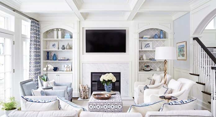 White living room with a marble fireplace and a flatscreen tv.