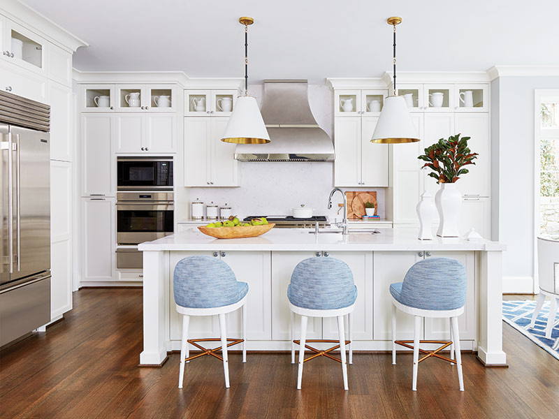 A white kitchen with blue-and-white bar stools.