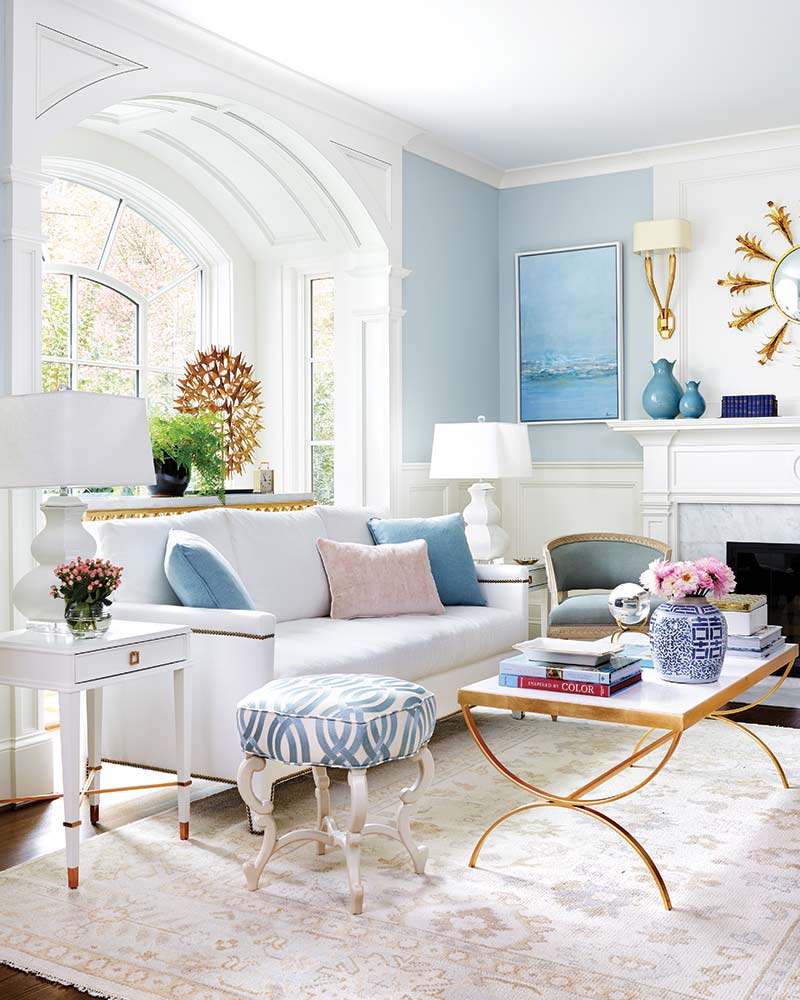 A living room with blue and light pink accents.