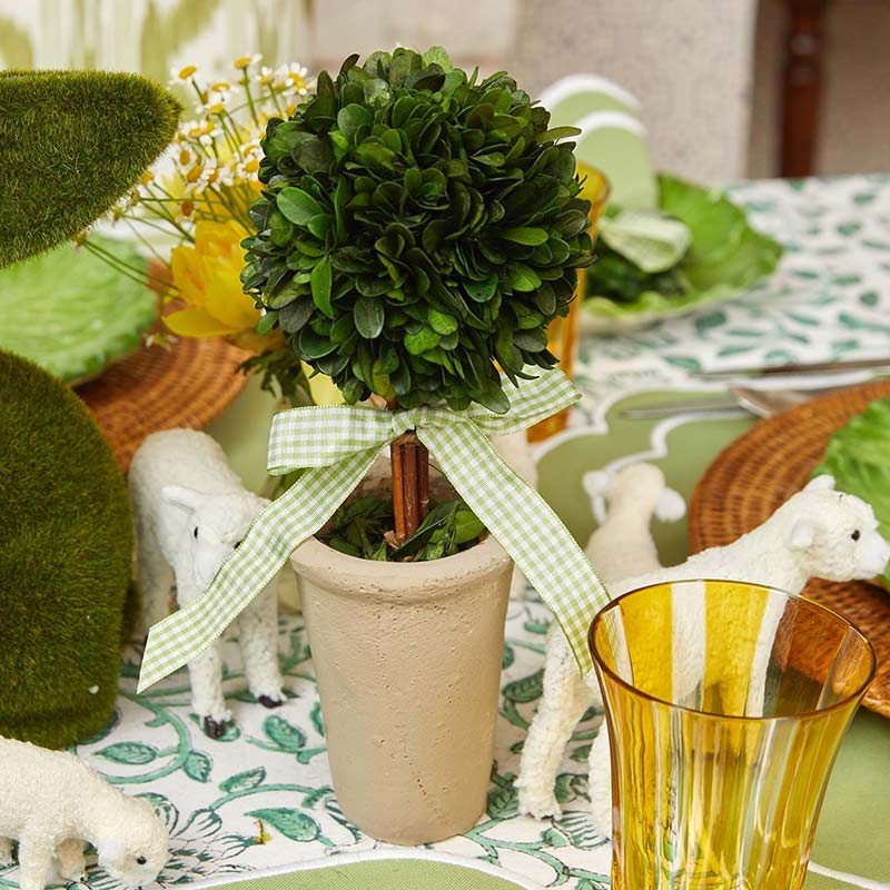 A small faux topiary embellished with a green-and-white gingham bow.