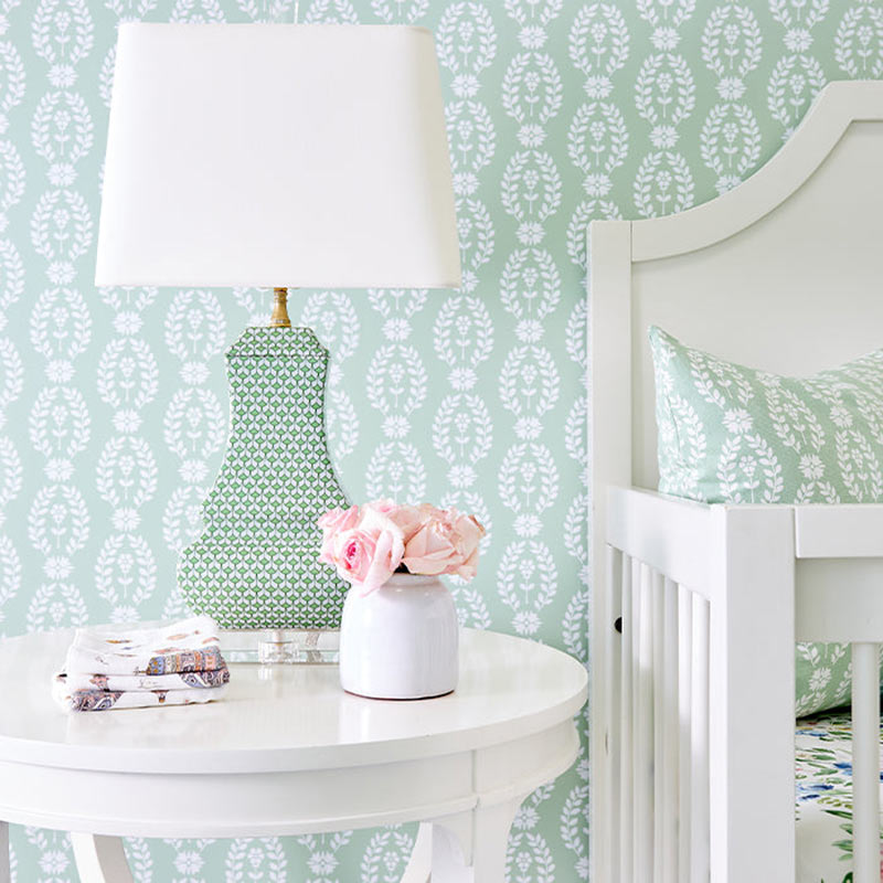 Mint green-and-white wallpaper in a nursery. 