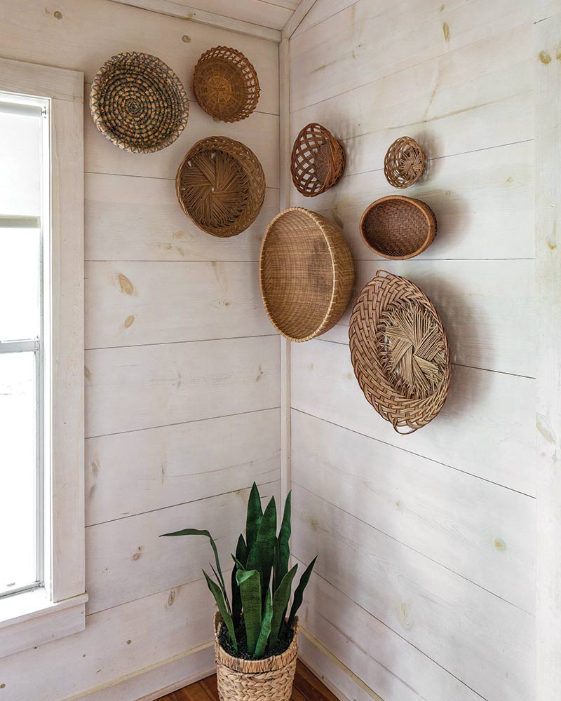 A corner wall embellished with a collection of woven baskets.