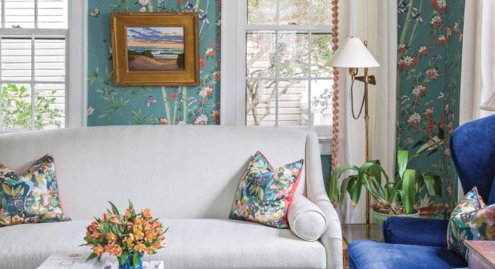 A living room with botanical wallpaper.