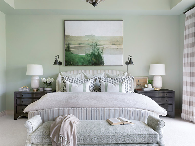 A bedroom furnished in seafoam green and white.