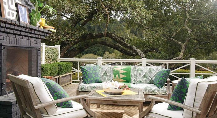 An outdoor sitting area with green pillows.