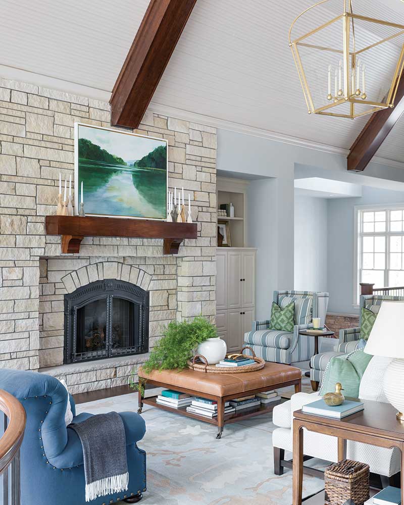 A living room featuring a stone fireplace.