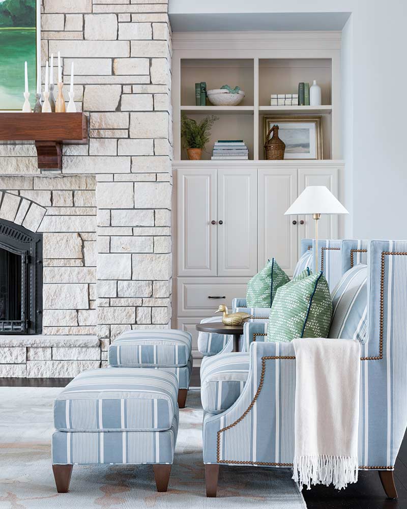 A living room with blue-and-white upholstered chairs.