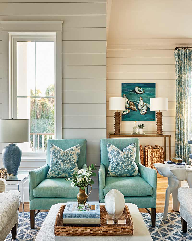 A living room with white and light blue furnishings.