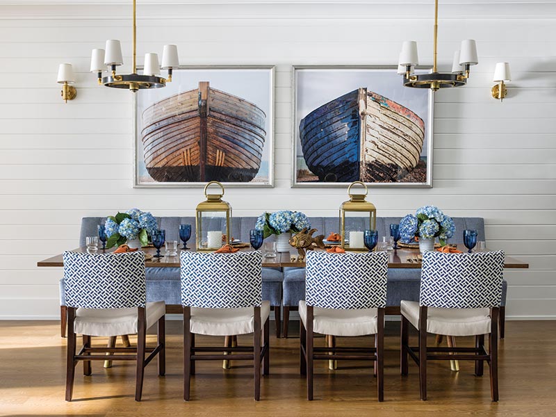 A dining area with shiplap walls and blue furnishings.