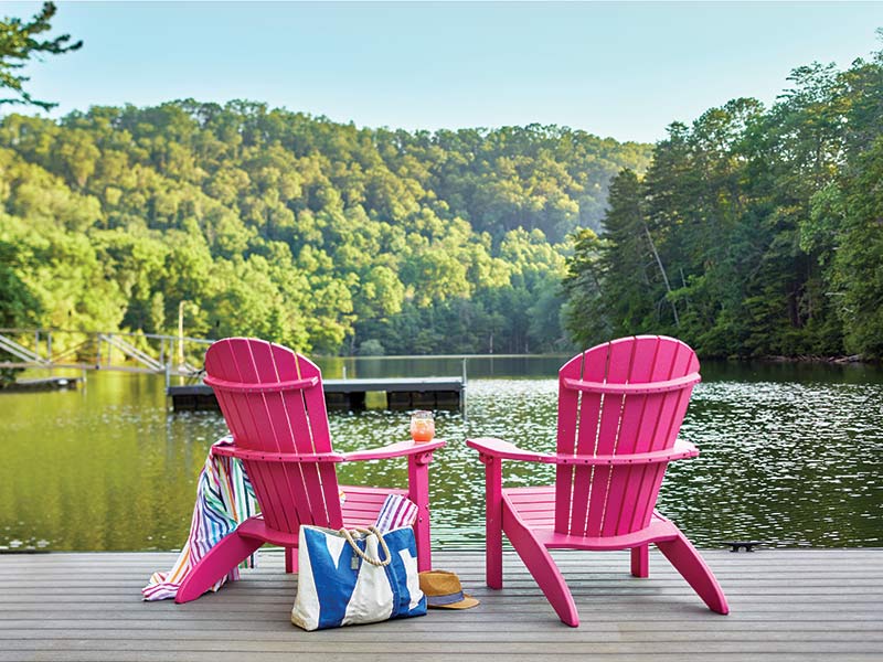 Two pink adorandak chairs on the dock. 