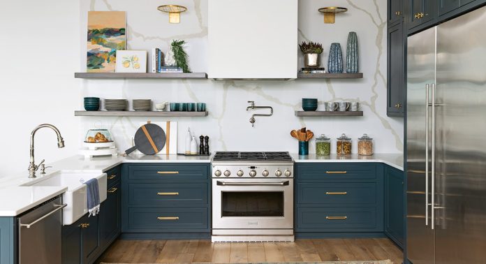 A contemporary kitchen with blue lower cabinets, white quartz countertops, and open shelving.