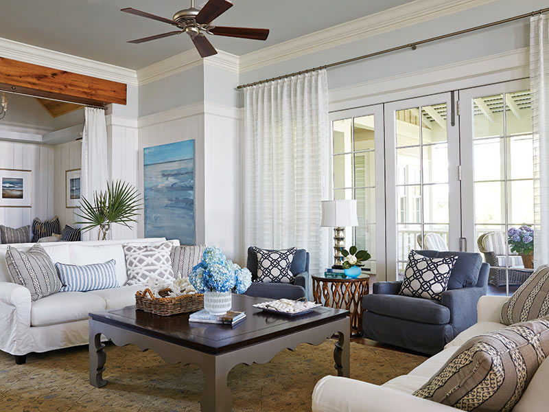 A living room furnished in blue and white with wood accents.