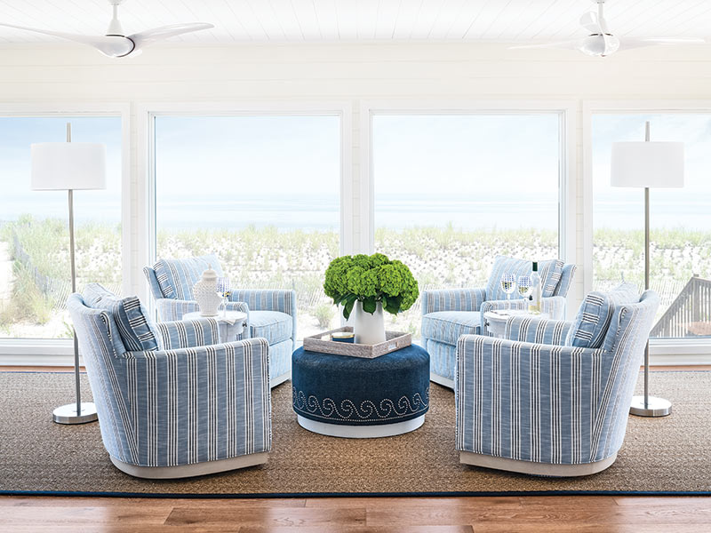 A blue-and-white sunroom overlooking the beach.