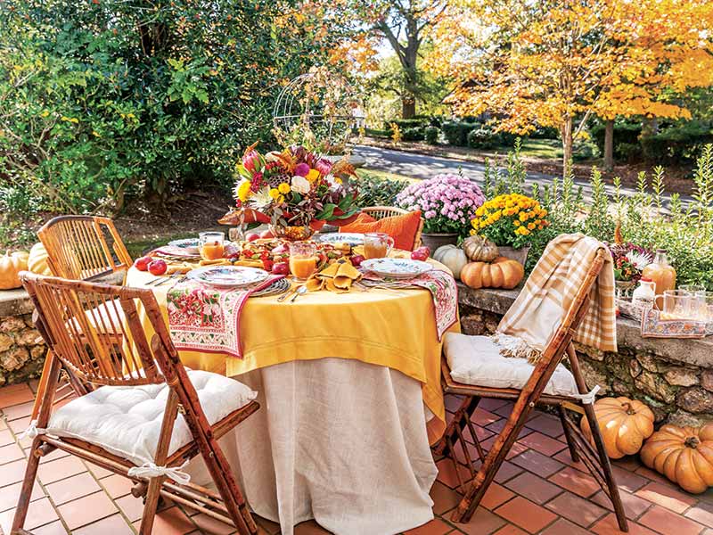 An alfresco tablescape with yellow, orange, and red accents.