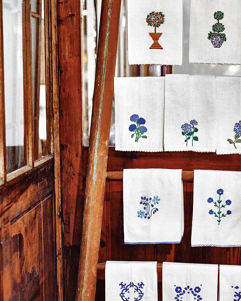 Hand-embroidered linens on a stand.